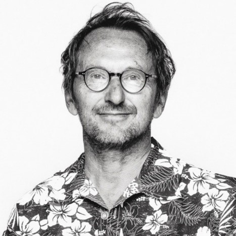 Schwarz-weiß Porträt von Martin Langer. Er trägt eine runde Brille und ein Hawaii-Hemd.